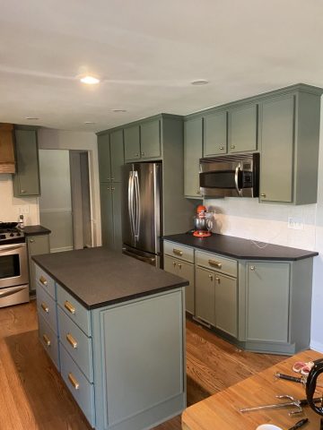 Kitchen cabinets refaced to be a pastel green with brass knobs and pulls Kitchen cabinets refaced to be a pastel green with brass knobs and pulls