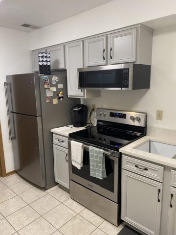 Kitchen cabinets refaced to be grey Kitchen cabinets refaced to be grey with new black door knobs and drawer pulls